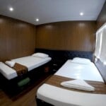 cabin Comfortable hotel room with two single beds and modern decor.