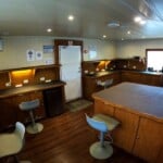 camera room c Interior of a ship's control room with desks and chairs.