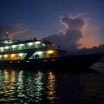 ship at night Luxury yacht at sunset in Tubbataha, Philippines, showcasing the Infiniti Tour Tubbataha.
