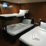 standardroom tripleshare Bunk beds inside a cruise cabin on Infiniti Tour Tubbataha.