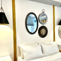 Elegant hotel room featuring stylish mirrors and contemporary lighting fixtures at Hotel1 Princesa.