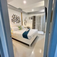 Hotel room with modern decor and cozy bedding in Princesa, Philippines.