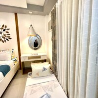 Comfortable hotel room with modern decor and natural light.