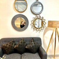 Stylish hotel lounge with decorative mirrors and a comfortable sofa with patterned cushions.