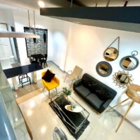 Modern living room with stylish decor and mirrors.