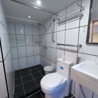 Bathroom with shower, toilet, and sink on a Dolphin Liveaboard vessel.