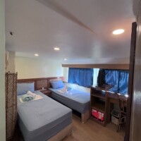 Comfortable cabin with twin beds and ocean view.