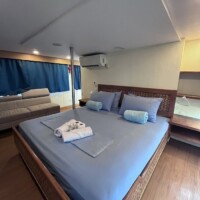 Dolphin Liveaboard room with comfortable bed, towels, and modern amenities.