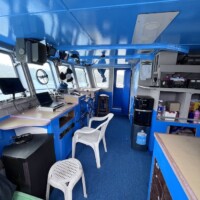 Bridge navigation station on Dolphin Liveaboard with control panels and communication equipment.