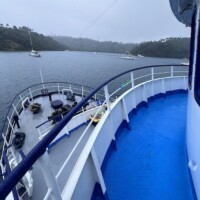 Scenic view from the Dolphin Liveaboard showing calm waters and anchored boats in the Philippines, p.