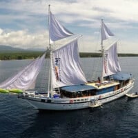 Beautiful Siren Liveaboard sailing on calm Philippine waters with sails unfurled.