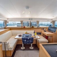 Luxury yacht interior with dining area and ocean view, perfect for island hopping in the Philippines.