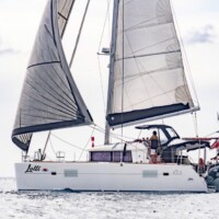 Luxury sailing yacht with large sails on calm ocean waters in the Philippines.