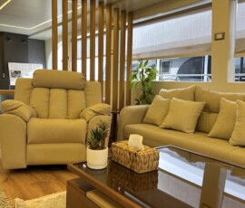 Modern hotel lounge featuring cozy beige sofas, natural light, and decorative accents. Bright, stylish hotel lounge with comfortable beige sofas and modern decor.