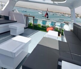 Enjoy stunning views of the Philippines' islands from this elegant yacht deck, ideal for leisure and travel tips. Marina view from a modern yacht featuring sleek seating and panoramic water scenery.