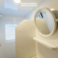 Comfortable cruise ship accommodation with a mirror and window view. Ensuite room with a mirror and window on a cruise ship.