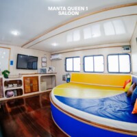 Comfortable and modern lounge area on the Manta Queen 1, perfect for relaxing during island hopping tours. Saloon on the Manta Queen 1 cruise ship in the Philippines.