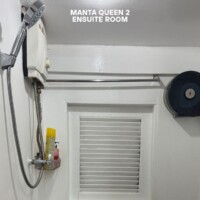 Comfortable cruise ship ensuite with shower and ventilation system. Ensuite bathroom in Manta Queen 2 cruise ship, featuring shower and ventilation.