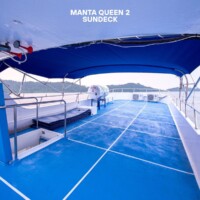 Relaxing on the sun deck of Manta Queen 2 during island hopping in the Philippines. Sun deck of Manta Queen 2 yacht in the Philippines.