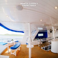 Elegant yacht dining space with ocean scenery, perfect for relaxing meals. Luxury yacht dining area with ocean view and modern interior design.