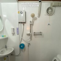 Comfortable bathroom setup in the Manta Queen 3 cruise ship. Ensuite bathroom with shower and sink in Manta Queen 3.