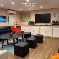 Relaxing Manta Queen 3 lounge with cozy seating and TV for guests. Manta Queen 3 saloon with comfortable seating and entertainment area in the Philippines.