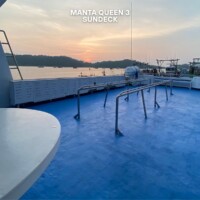 Relaxing sunset view from the deck of Manta Queen 3, a popular boat for island hopping in the Philippines. Sunset view from Manta Queen 3's sun deck in the Philippines.