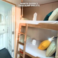 Comfortable twin bunk beds with ensuite bathroom on the Manta Queen 3 cruise ship in the Philippines. Twin bunk bed with private bathroom on Manta Queen 3 cruise.