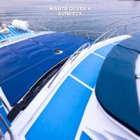 Relax on the Manta Queen 6 yacht's sun deck, perfect for enjoying the sea views and sunshine during island hopping trips. Manta Queen 6 yacht deck with sun protection and seating area.